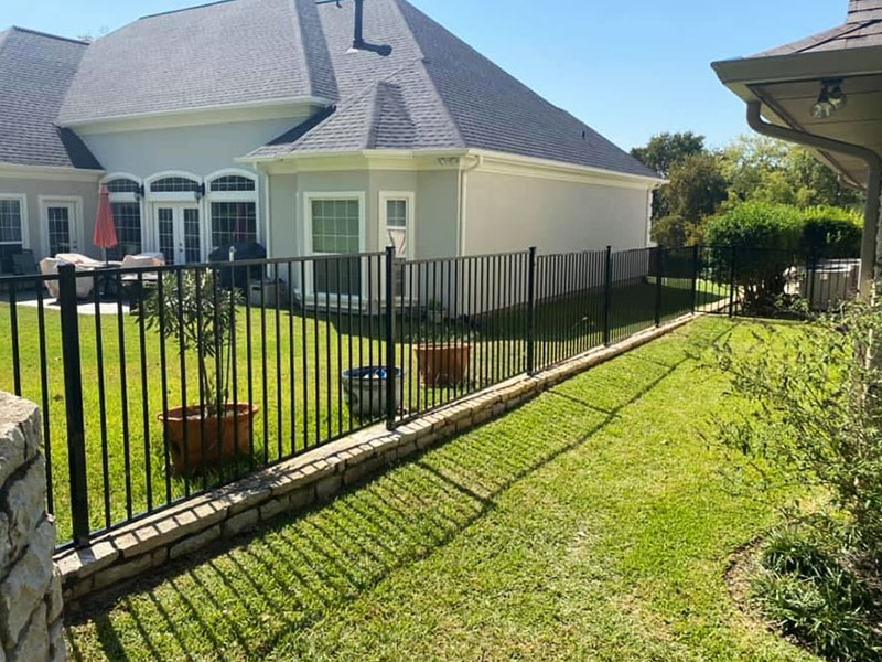 residential house with a metallic fence installed granbury tx